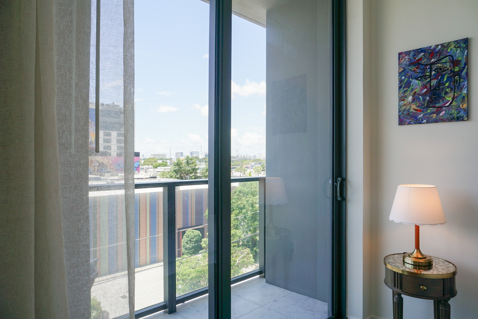 Bedroom balcony door — Wynwood skyline and Gabe Weis painting
