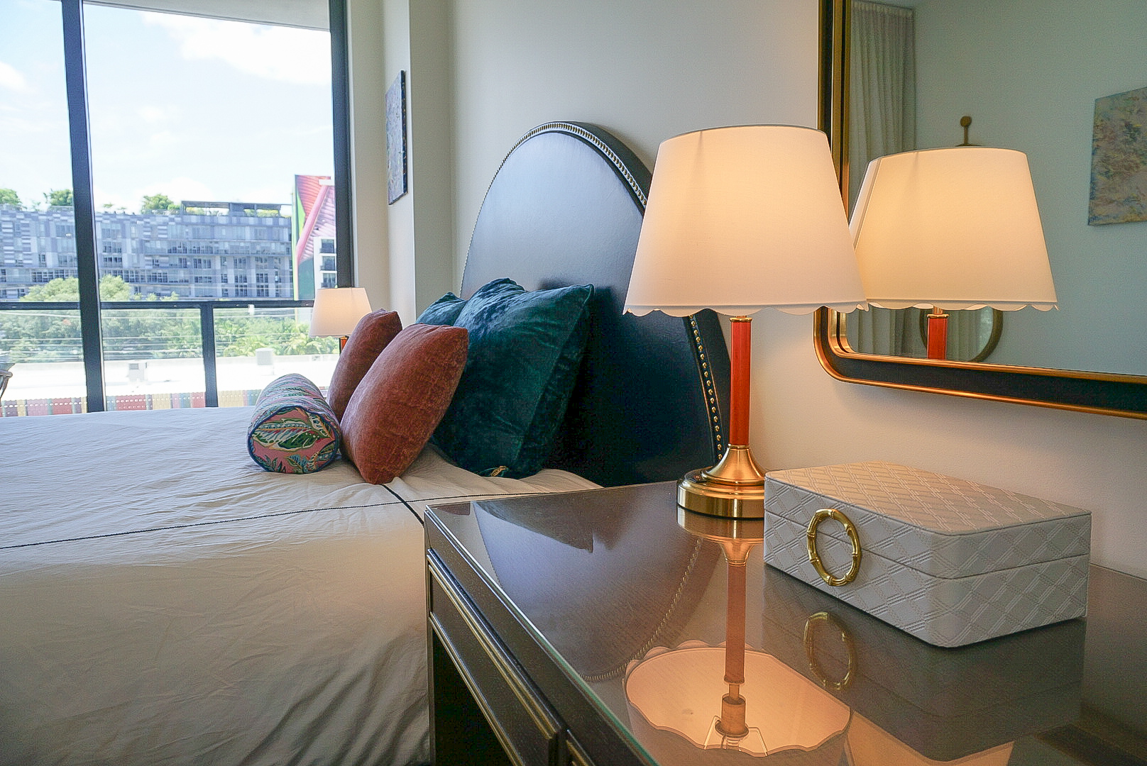 Bedroom desk and lamp — vintage lamp, velvet pillows, city view