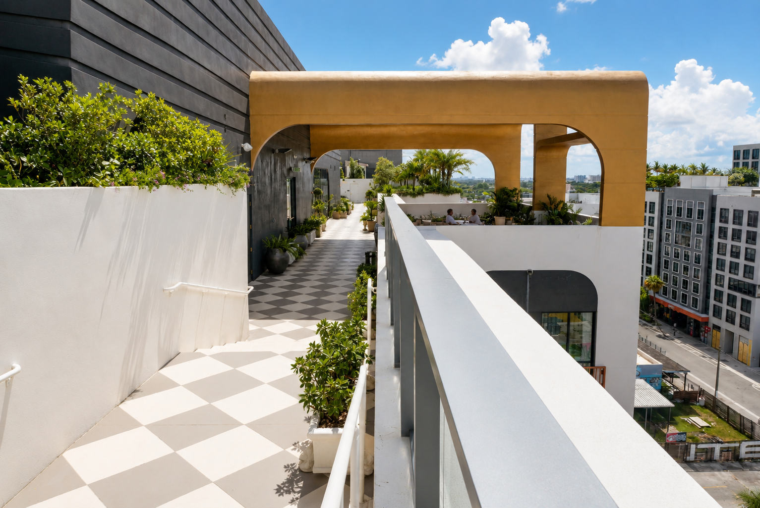 Rooftop walkway — gold arched canopy, aerial Wynwood view