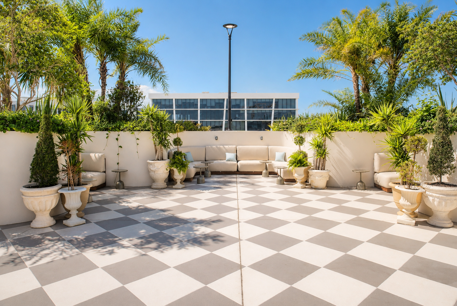 Rooftop garden — palm trees, lush planters, open-air seating